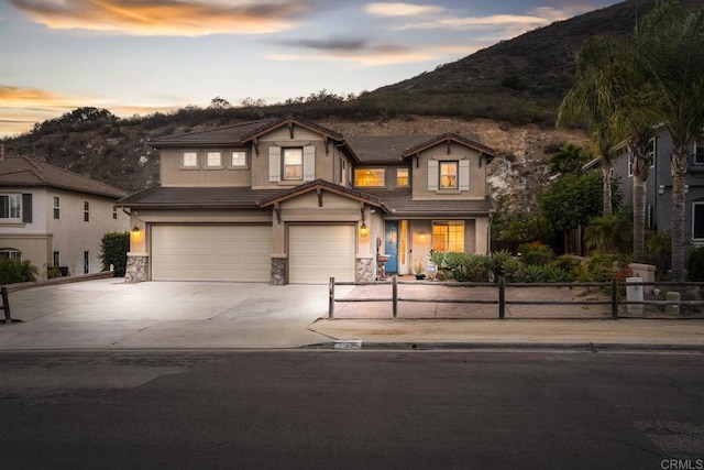737 W Bel Esprit Cir, San Marcos, CA 92069 - view of front of property featuring stucco siding, a garage, a mountain view, stone siding, and concrete driveway