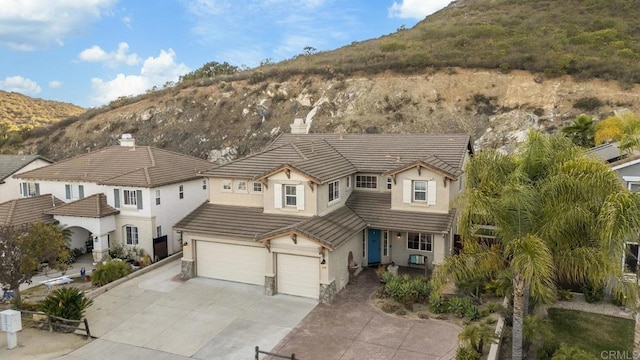 737 W Bel Esprit Cir, San Marcos, CA 92069 - view of front of property featuring stucco siding, a mountain view, driveway, and an attached garage