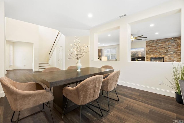 737 W Bel Esprit Cir, San Marcos, CA 92069 - dining space with stairs, dark wood finished floors, recessed lighting, ceiling fan, and a stone fireplace