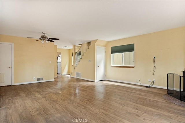 33159 Ridge Rd, Arrowbear, CA 92308 - unfurnished living room with a ceiling fan, wood finished floors, and stairway