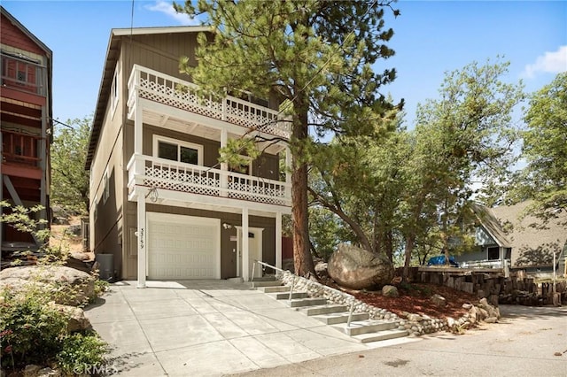 33159 Ridge Rd, Arrowbear, CA 92308 - view of front of home with a balcony, concrete driveway, and a garage