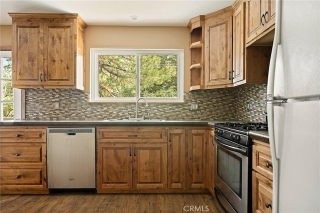 33159 Ridge Rd, Arrowbear, CA 92308 - kitchen featuring stainless steel appliances, dark countertops, backsplash, open shelves, and brown cabinetry