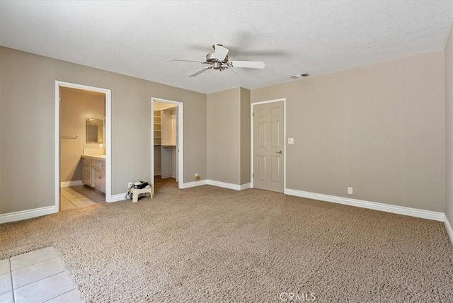 836 Bolen Dr, Paso Robles, CA 93446 - unfurnished bedroom with a spacious closet, light carpet, a closet, a ceiling fan, and connected bathroom