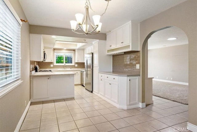 836 Bolen Dr, Paso Robles, CA 93446 - kitchen with stainless steel appliances, arched walkways, tasteful backsplash, and light tile patterned floors