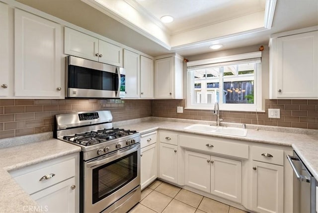 836 Bolen Dr, Paso Robles, CA 93446 - kitchen with appliances with stainless steel finishes, ornamental molding, a raised ceiling, white cabinets, and light countertops