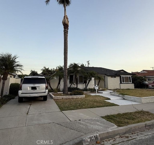 1016 W Teresa St, West Covina, CA 91790 - ranch-style house with driveway, a lawn, and stucco siding