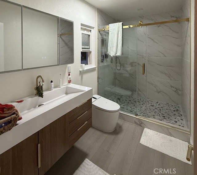 1016 W Teresa St, West Covina, CA 91790 - full bath featuring vanity, a marble finish shower, and wood finished floors