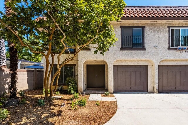 516 Sefton Ave Unit A, Monterey Park, CA 91755 - view of front of home featuring a tiled roof, driveway, stucco siding, and a garage