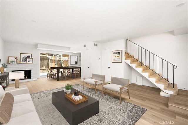 516 Sefton Ave Unit A, Monterey Park, CA 91755 - living area with wood finished floors, stairway, and a brick fireplace