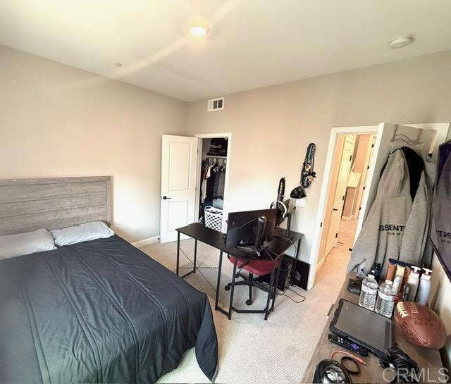 1959 Minimalist Ln, Chula Vista, CA 91915 - bedroom featuring light colored carpet, a desk, and a closet