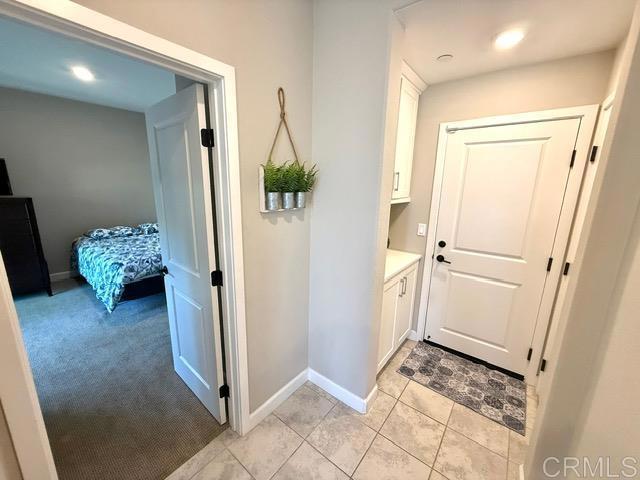 1959 Minimalist Ln, Chula Vista, CA 91915 - doorway to outside with light carpet, light tile patterned floors, and recessed lighting