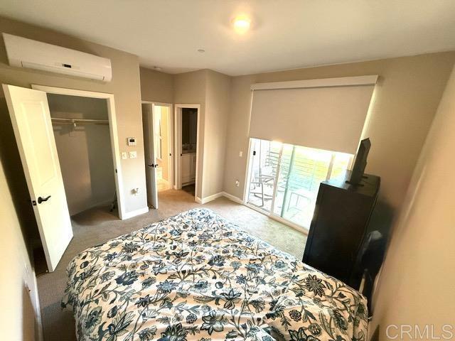 1959 Minimalist Ln, Chula Vista, CA 91915 - carpeted bedroom featuring a wall unit AC and a closet
