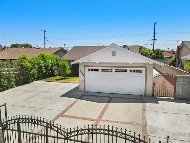10265 Lev Ave, Arleta, CA 91331 - view of front facade with a gate, a fenced front yard, a detached garage, an outbuilding, and stucco siding