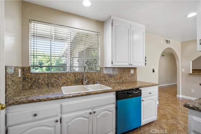 10265 Lev Ave, Arleta, CA 91331 - kitchen with dishwashing machine, white cabinets, light tile patterned floors, arched walkways, and tasteful backsplash