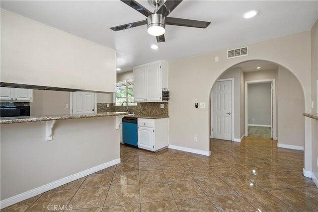 10265 Lev Ave, Arleta, CA 91331 - kitchen featuring dishwashing machine, white cabinetry, ceiling fan, light stone countertops, and backsplash