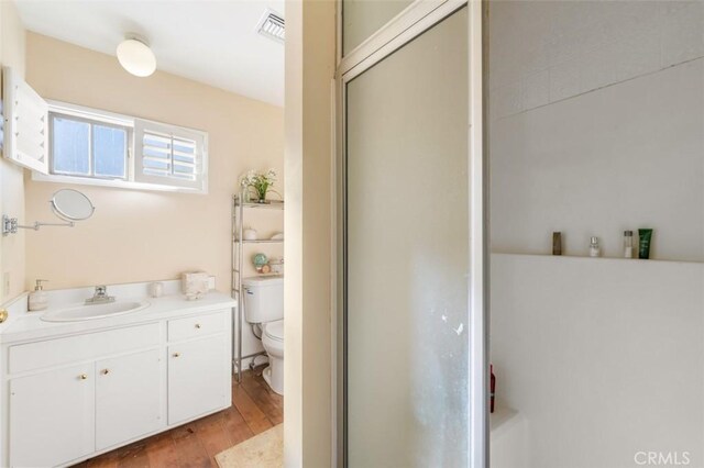5250 Scott Robertson Rd, Hidden Hills, CA 91302 - full bathroom featuring wood finished floors, vanity, and a shower with door