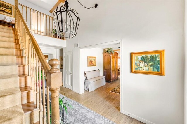 5250 Scott Robertson Rd, Hidden Hills, CA 91302 - entrance foyer featuring light wood-style flooring, a chandelier, stairs, and a towering ceiling