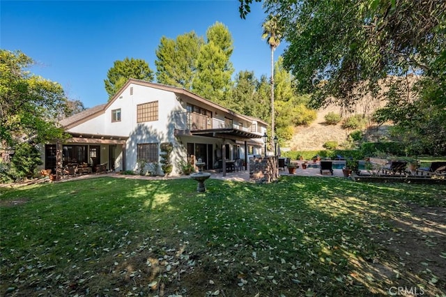 5250 Scott Robertson Rd, Hidden Hills, CA 91302 - back of property with a patio area, a lawn, and stucco siding