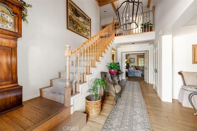 5250 Scott Robertson Rd, Hidden Hills, CA 91302 - entryway featuring a chandelier, stairs, wood finished floors, and a towering ceiling