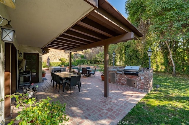 5250 Scott Robertson Rd, Hidden Hills, CA 91302 - view of patio featuring an outdoor kitchen and outdoor dining space