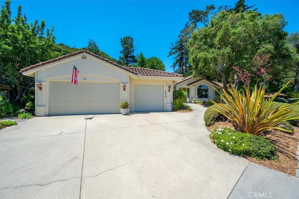 1989 Royal, San Luis Obispo, CA 93405 - mediterranean / spanish home with a garage, driveway, a tile roof, and stucco siding