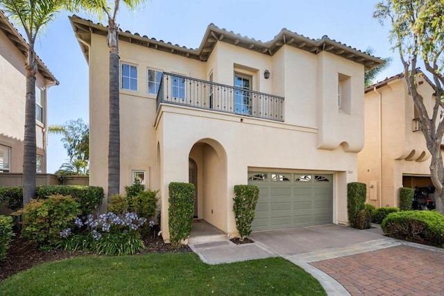 7243 Surfbird Cir, Carlsbad, CA 92011 - mediterranean / spanish home with a balcony, decorative driveway, an attached garage, and stucco siding