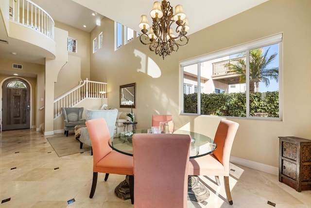 7243 Surfbird Cir, Carlsbad, CA 92011 - dining room featuring stairs, a chandelier, a towering ceiling, and recessed lighting