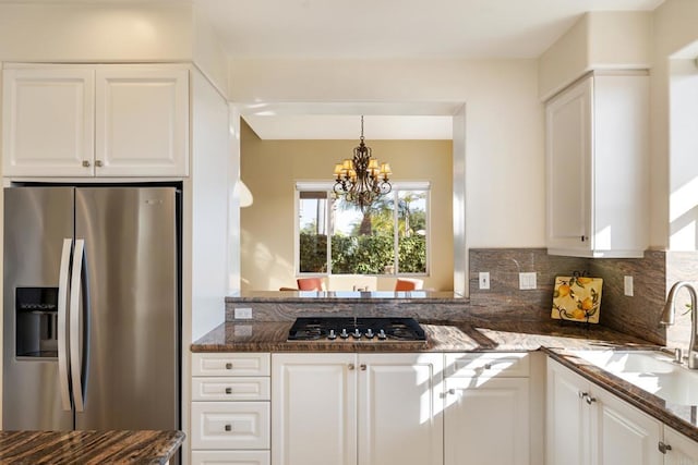 7243 Surfbird Cir, Carlsbad, CA 92011 - kitchen featuring stainless steel appliances, white cabinets, a chandelier, and dark stone countertops