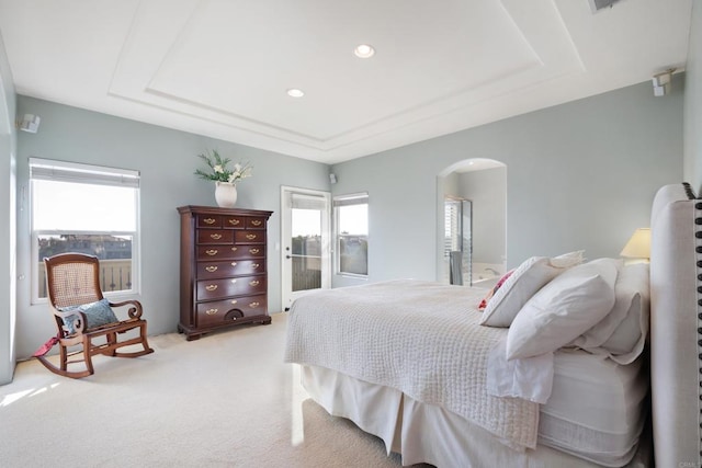7243 Surfbird Cir, Carlsbad, CA 92011 - bedroom featuring arched walkways, a raised ceiling, light colored carpet, and recessed lighting