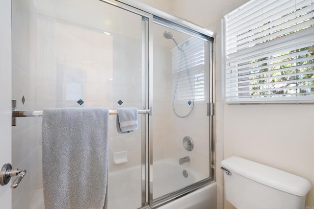 7243 Surfbird Cir, Carlsbad, CA 92011 - bathroom featuring toilet and combined bath / shower with glass door