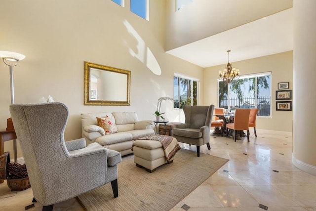 7243 Surfbird Cir, Carlsbad, CA 92011 - living area featuring a chandelier, a towering ceiling, and light tile patterned floors