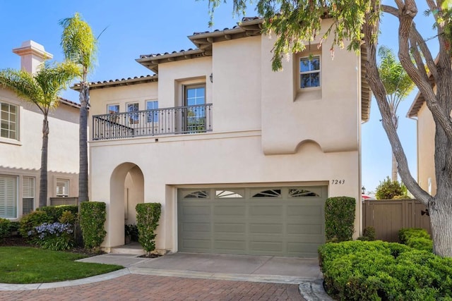 7243 Surfbird Cir, Carlsbad, CA 92011 - mediterranean / spanish house with a balcony, stucco siding, driveway, and a garage