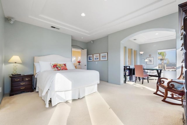 7243 Surfbird Cir, Carlsbad, CA 92011 - bedroom with a tray ceiling, arched walkways, light colored carpet, and recessed lighting