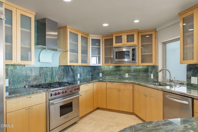 3629 Ocean Dr, Oxnard, CA 93035 - kitchen with appliances with stainless steel finishes, wall chimney range hood, decorative backsplash, dark stone countertops, and recessed lighting