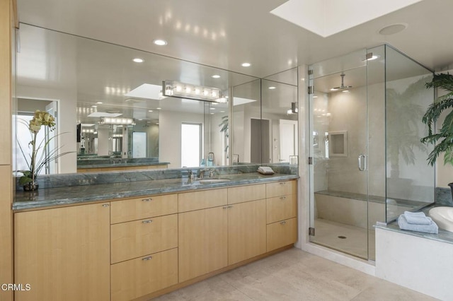 3629 Ocean Dr, Oxnard, CA 93035 - bathroom featuring a shower stall, vanity, a bathtub, tile patterned floors, and a skylight