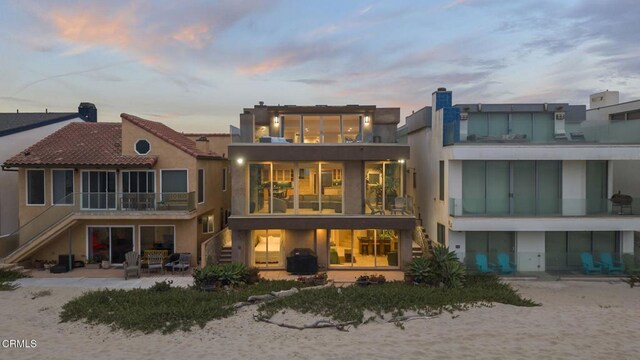 3629 Ocean Dr, Oxnard, CA 93035 - rear view of house with stairway, a patio area, stucco siding, and a balcony