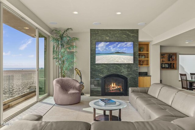 3629 Ocean Dr, Oxnard, CA 93035 - living room with built in shelves, healthy amount of natural light, recessed lighting, a fireplace, and a water view