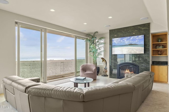 3629 Ocean Dr, Oxnard, CA 93035 - living room with a water view, a fireplace, recessed lighting, and built in features