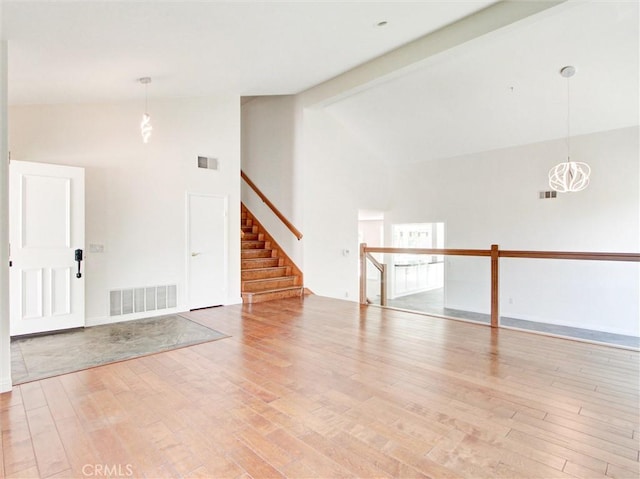 20472 Via Marwah, Yorba Linda, CA 92886 - spare room with high vaulted ceiling, light wood-type flooring, stairway, and a chandelier