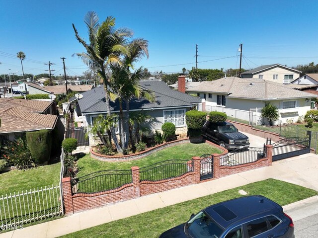 2165 W 115th St, Hawthorne, CA 90250 - view of front of home featuring a fenced front yard, a residential view, and a gate