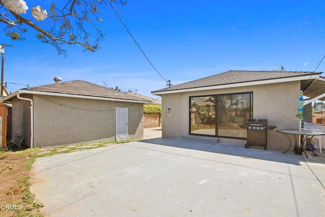 2165 W 115th St, Hawthorne, CA 90250 - rear view of property with stucco siding and a patio