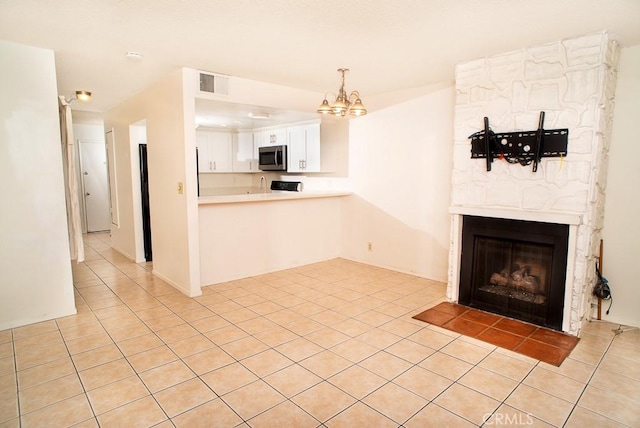 1718 Puente Ave Unit 40, Baldwin Park, CA 91706 - unfurnished living room with light tile patterned floors, a chandelier, and a fireplace