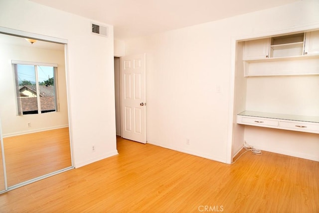 1718 Puente Ave Unit 40, Baldwin Park, CA 91706 - spare room with built in desk and light wood-style floors