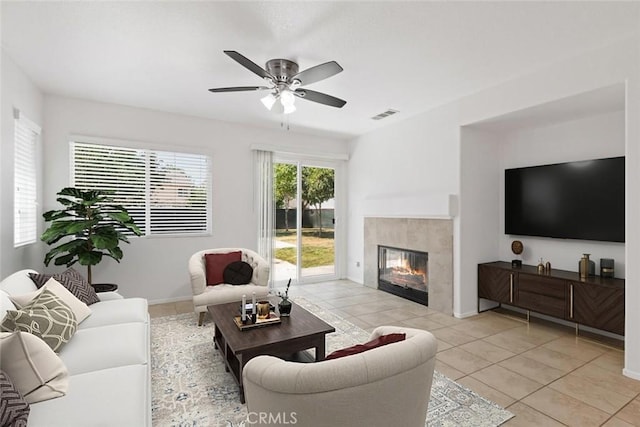 5185 Konic Ct, Riverside, CA 92509 - living area featuring light tile patterned floors, a ceiling fan, and a tiled fireplace