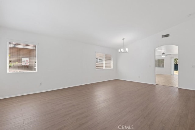 5185 Konic Ct, Riverside, CA 92509 - empty room with a ceiling fan, wood finished floors, a chandelier, and arched walkways