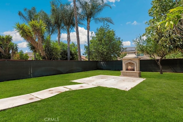 5185 Konic Ct, Riverside, CA 92509 - fenced backyard with a tiled fireplace and a patio area