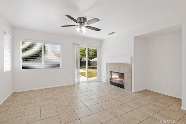 5185 Konic Ct, Riverside, CA 92509 - unfurnished living room featuring light tile patterned floors, ceiling fan, and a tiled fireplace