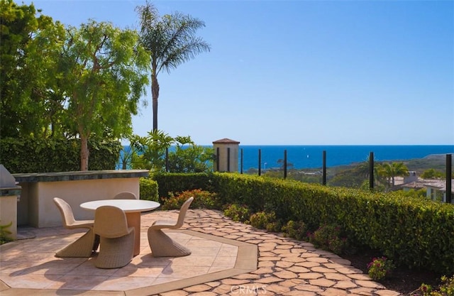 3 Atlantis Cv, Newport Coast, CA 92657 - view of patio / terrace with outdoor dining area and a water view