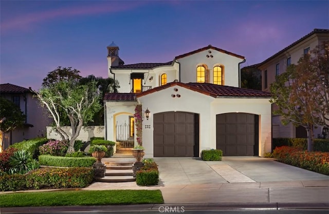 3 Atlantis Cv, Newport Coast, CA 92657 - mediterranean / spanish-style house featuring driveway, a garage, stucco siding, and a tiled roof
