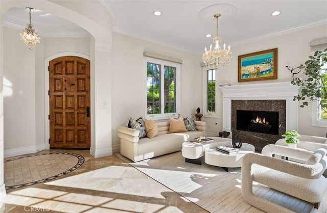 3 Atlantis Cv, Newport Coast, CA 92657 - living room with a chandelier, inlaid floor details, arched walkways, recessed lighting, and a fireplace